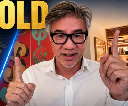 Gray-haired man in glasses and white shirt points both index fingers up, with yellow text and currency symbols behind him